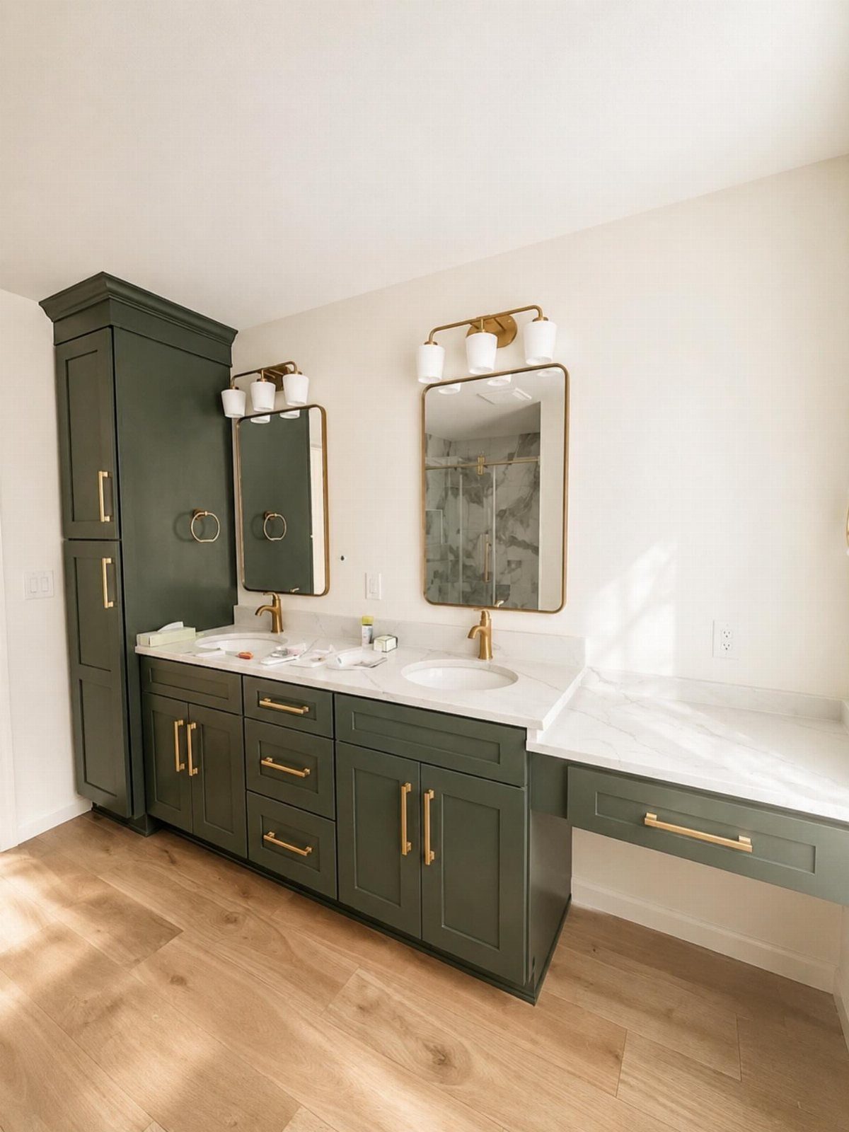 28 Bathroom Cabinet Ideas Storage Fixes for Small Spaces 20 Dark green bathroom vanity and tall cabinet with gold handles and white countertop.