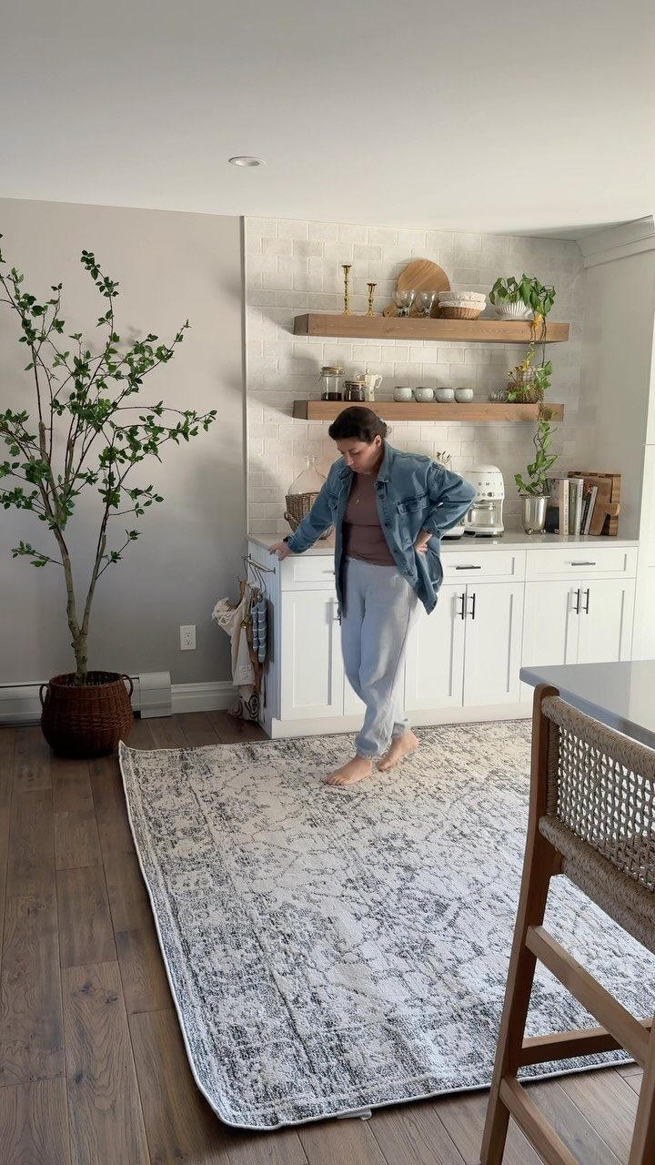 32 U Kitchen Design Ideas for Small, Open and Island Layouts 11 Patterned grey and white area rug on a wooden kitchen floor with white cabinets.