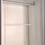 White closet interior with a top shelf and metal wire shelving unit.