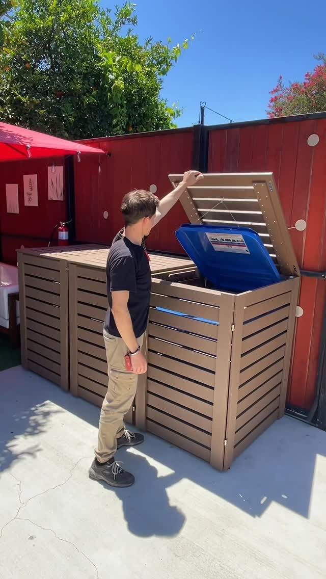 Movable Bar Counter Ideas: 8 Portable, Rolling and Home Styles 7 Man opening the lid of a brown slatted movable bar counter with a cooler.