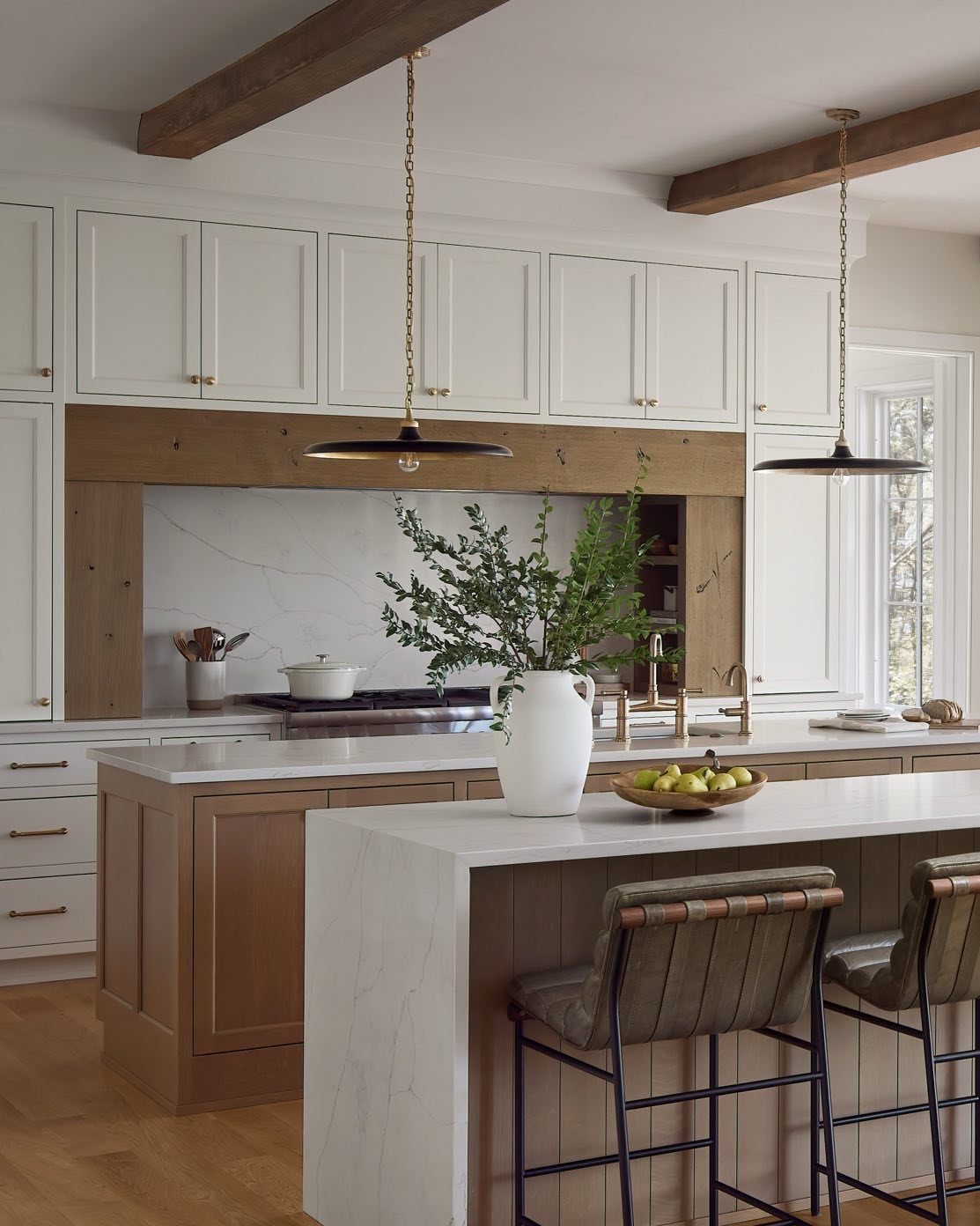 Kitchen Island with Seating on Two Sides: 10 Layout Ideas 9 Two parallel kitchen islands with white marble tops and leather bar stools.