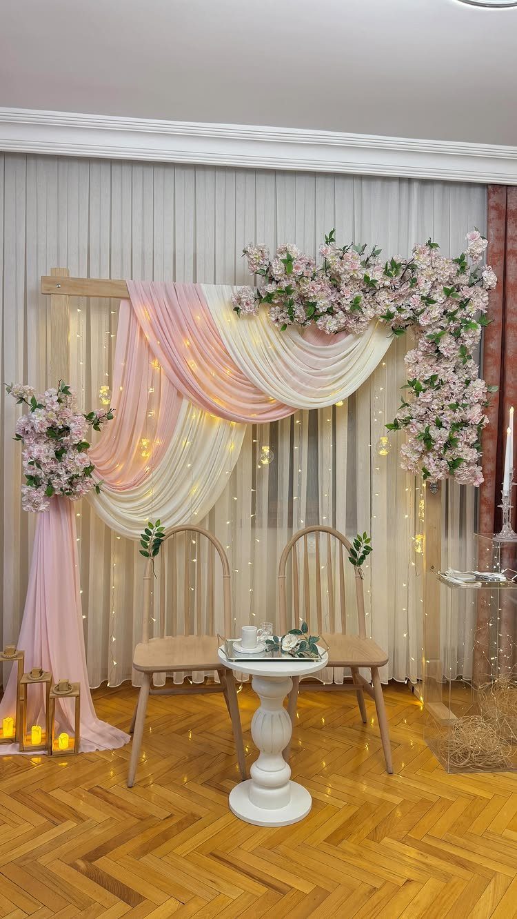 28 Wedding Decorations Ideas at Home with Flowers and Lights 15 Wedding decoration at home with pink fabric drapes, flowers, and fairy lights.