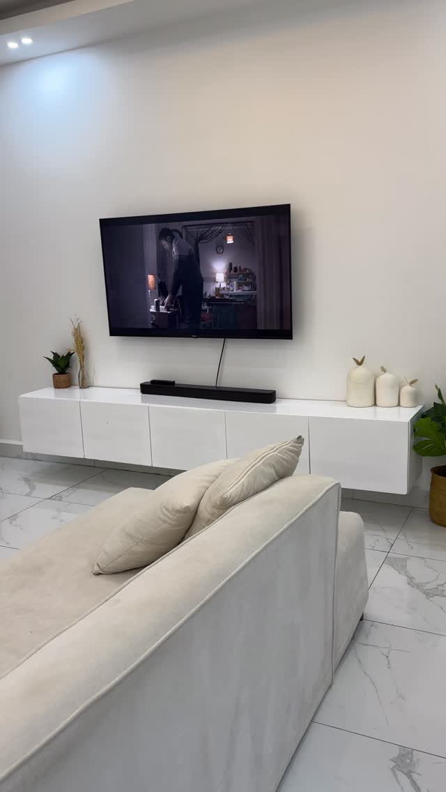 16 TV Designs for Living Room Walls, Units and Mounts 14 Wall-mounted TV above a white floating console in a modern living room