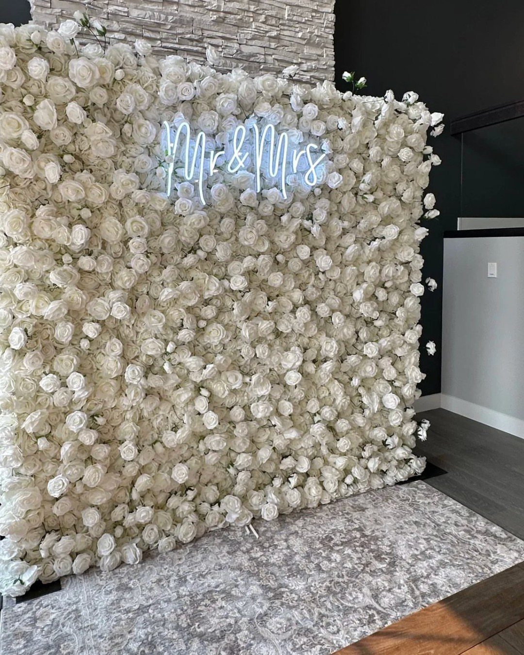 28 Wedding Decorations Ideas at Home with Flowers and Lights 21 White rose flower wall with a neon Mr and Mrs sign indoors.