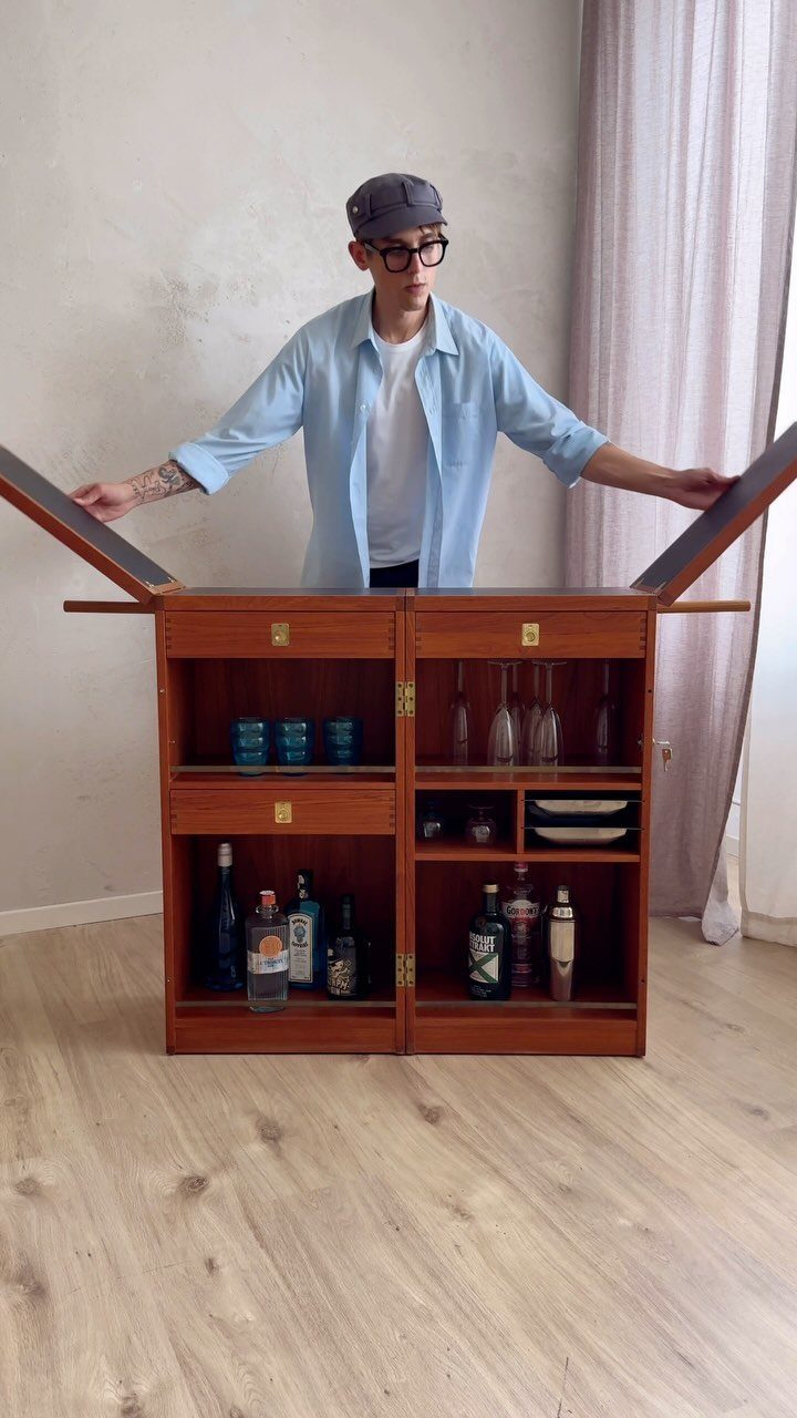 Movable Bar Counter Ideas: 8 Portable, Rolling and Home Styles 9 Wooden home bar cabinet with open shelves and extended side wings and a man.