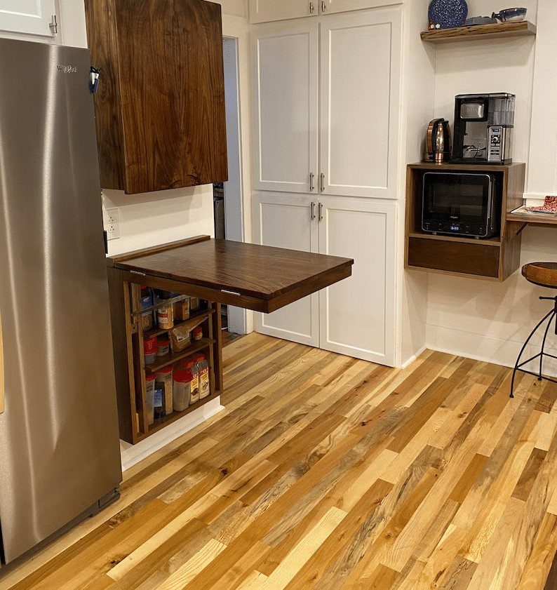 Fold-down wooden kitchen table with a built-in spice rack in a bright kitchen
