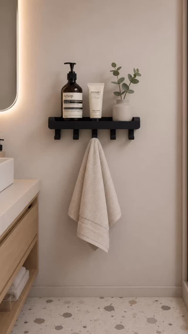 28 Bathroom Cabinet Ideas Storage Fixes for Small Spaces 27 Black wall-mounted shelf with bathroom toiletries and a hanging beige towel