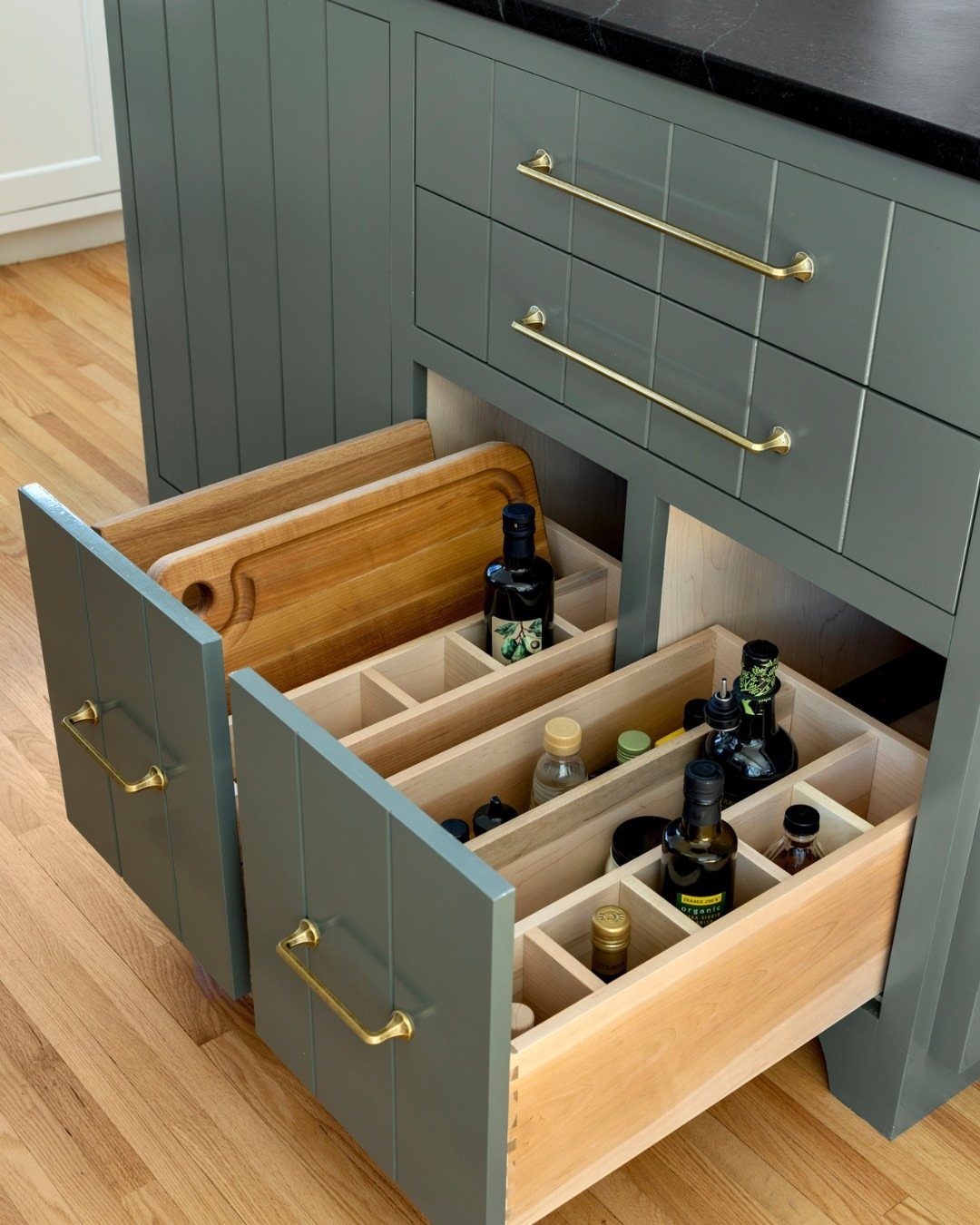 24 Small Kitchen Ideas 2026 for Storage, Style and Layout 14 Grey kitchen island with open deep drawers containing organized oils and cutting board.