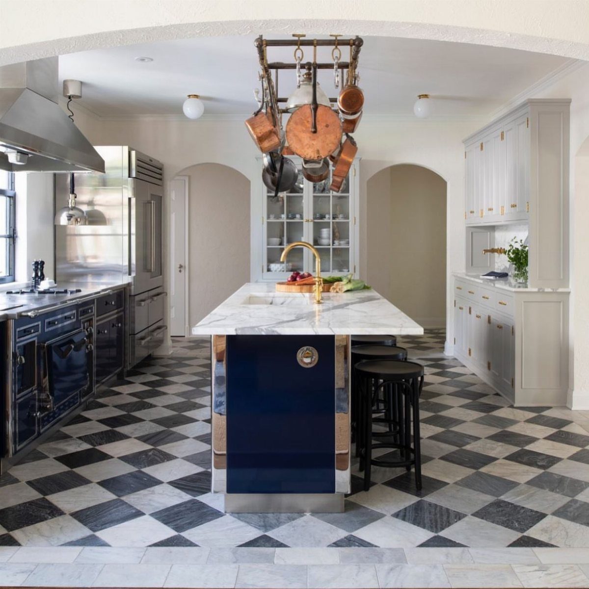 33 Kitchen Setting Ideas with Islands, Lighting, and Storage 19 Hanging metal pot rack with copper cookware above a blue kitchen island