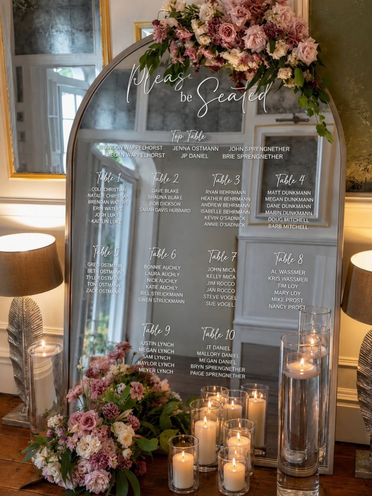 28 Wedding Decorations Ideas at Home with Flowers and Lights 14 Arched mirror seating chart decorated with pink flowers and white pillar candles.