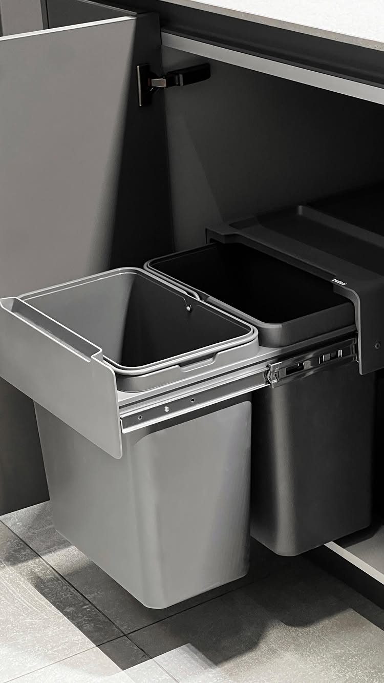32 U Kitchen Design Ideas for Small, Open and Island Layouts 24 Grey pull-out waste bins installed inside a modern grey kitchen cabinet.