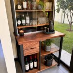 Wooden bar cabinet with glass-enclosed liquor display and lower storage shelves.
