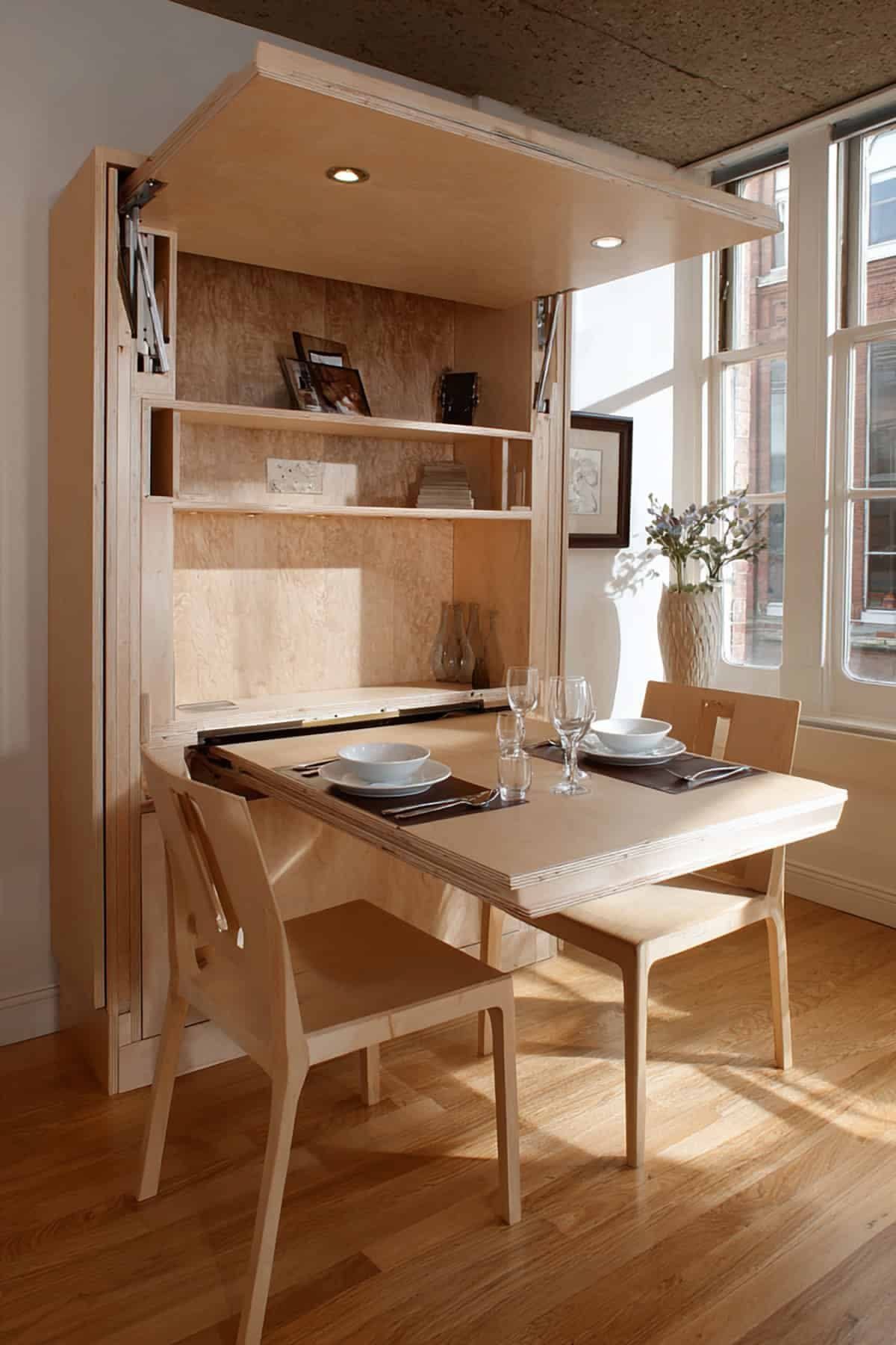 Hideaway Kitchen Table Ideas: 12 Fold-Away and Pull-Out Picks 2 Wall-mounted wooden Murphy table folded down with matching chairs and built-in shelving.