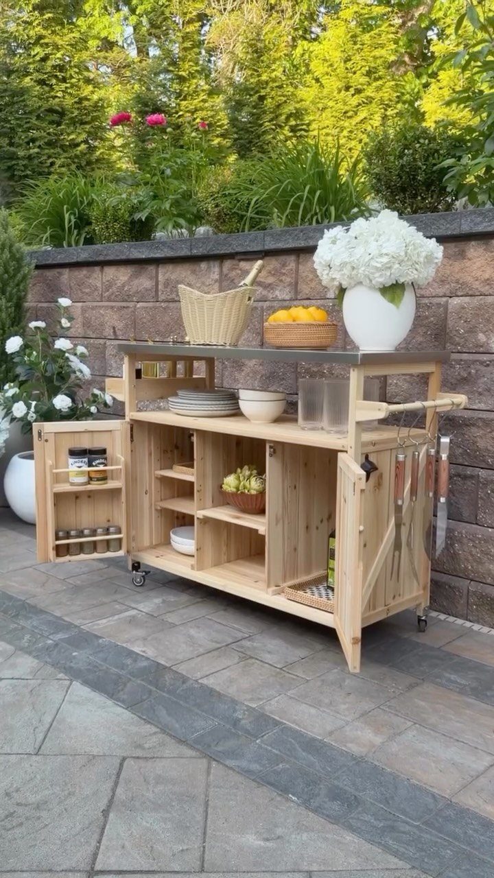 Movable Bar Counter Ideas: 8 Portable, Rolling and Home Styles 4 Wooden movable bar counter with grey top and open shelving on a stone patio.