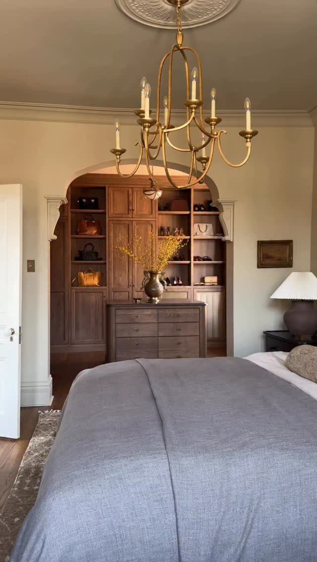 Bedroom Walk in Closet Layout: 17 Ideas to Try 2 Walk-in closet with brown wooden cabinetry and drawers viewed through a bedroom archway.