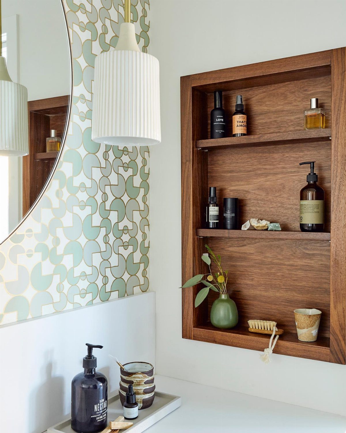 28 Bathroom Cabinet Ideas Storage Fixes for Small Spaces 11 Wooden recessed shelving unit built into a white wall holding various bathroom toiletries.
