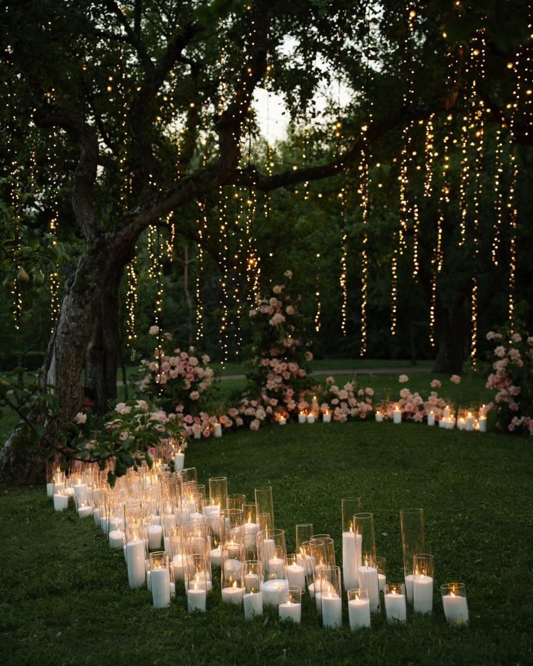 28 Wedding Decorations Ideas at Home with Flowers and Lights 20 Garden wedding decorations with hanging fairy lights, pink flowers, and white pillar candles.