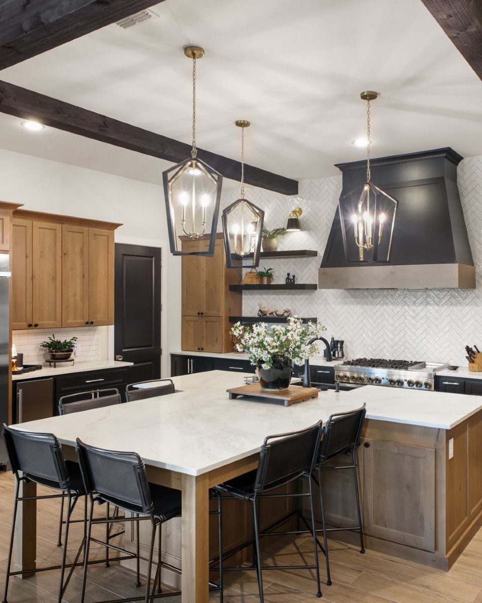 Kitchen Island with Seating on Two Sides: 10 Layout Ideas 2 Kitchen island with white marble top and black stools on opposing sides.