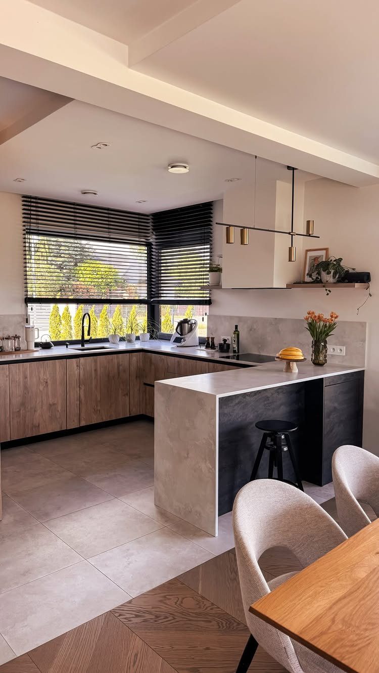 32 U Kitchen Design Ideas for Small, Open and Island Layouts 17 Modern U-shaped kitchen with a separate wooden dining table and white chairs in foreground.