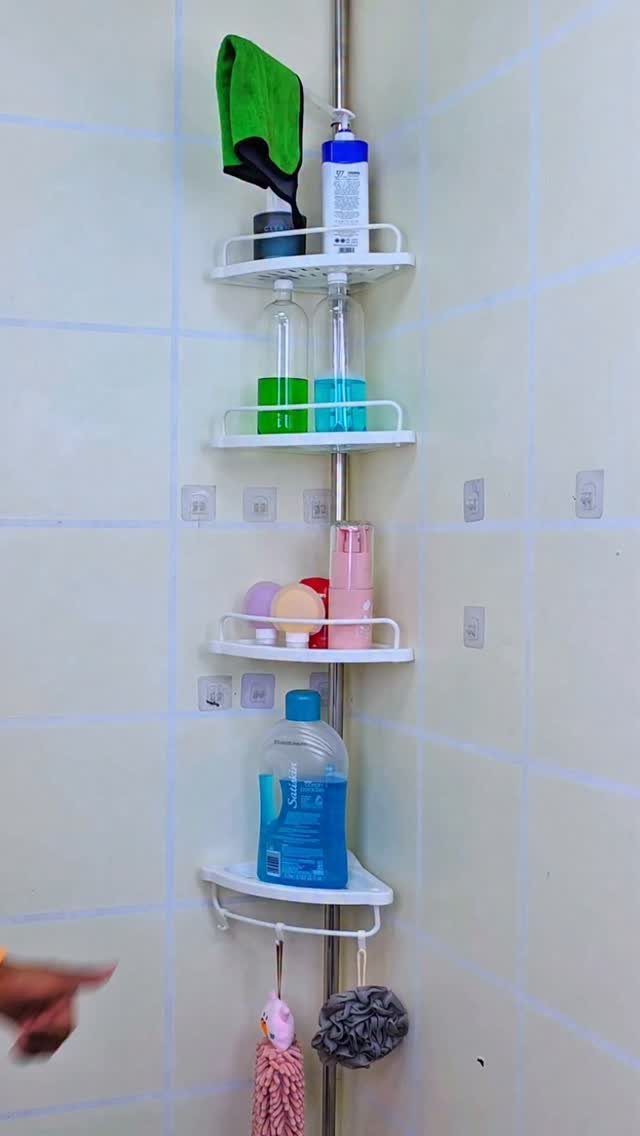 28 Bathroom Cabinet Ideas Storage Fixes for Small Spaces 26 White four-tier corner shower caddy holding toiletries against a light tiled wall.