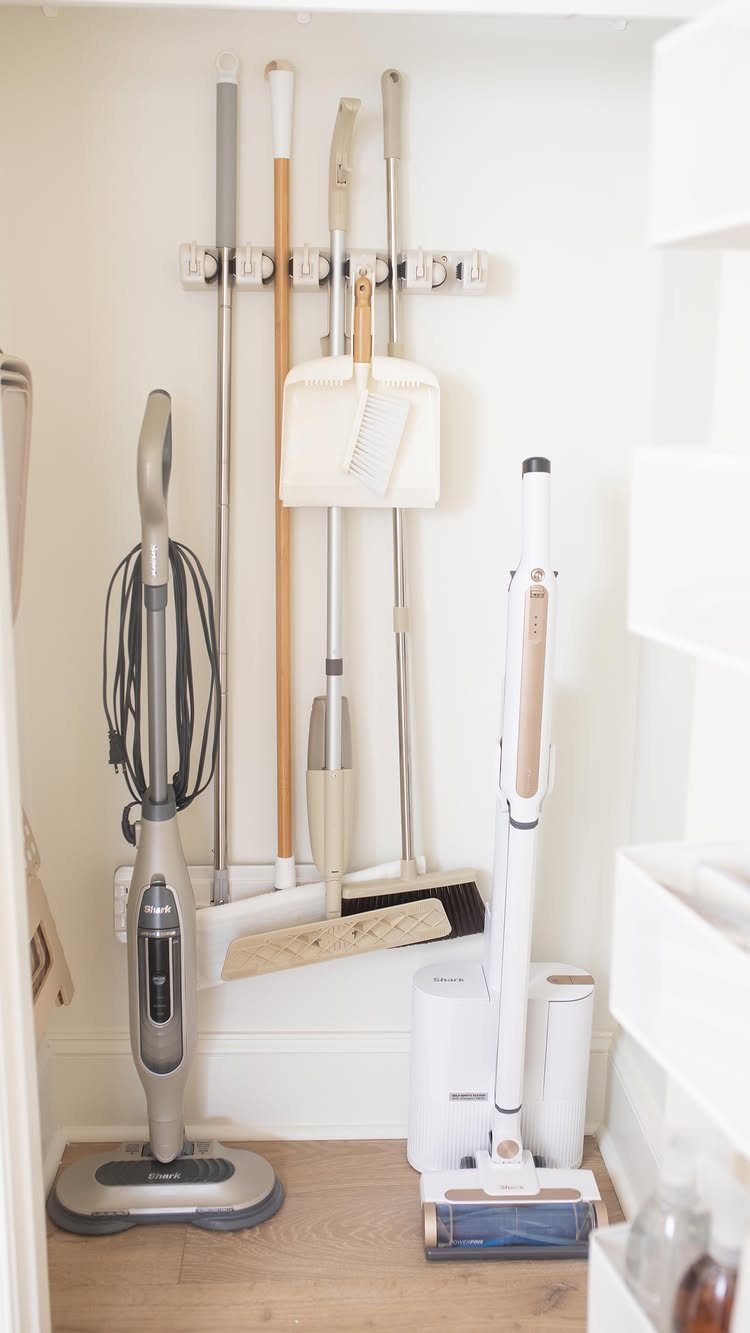 10 Broom Closet Design Ideas for Laundry Rooms and Stairs 7 Broom closet with tall cleaning tools on one side and shelves on the other.