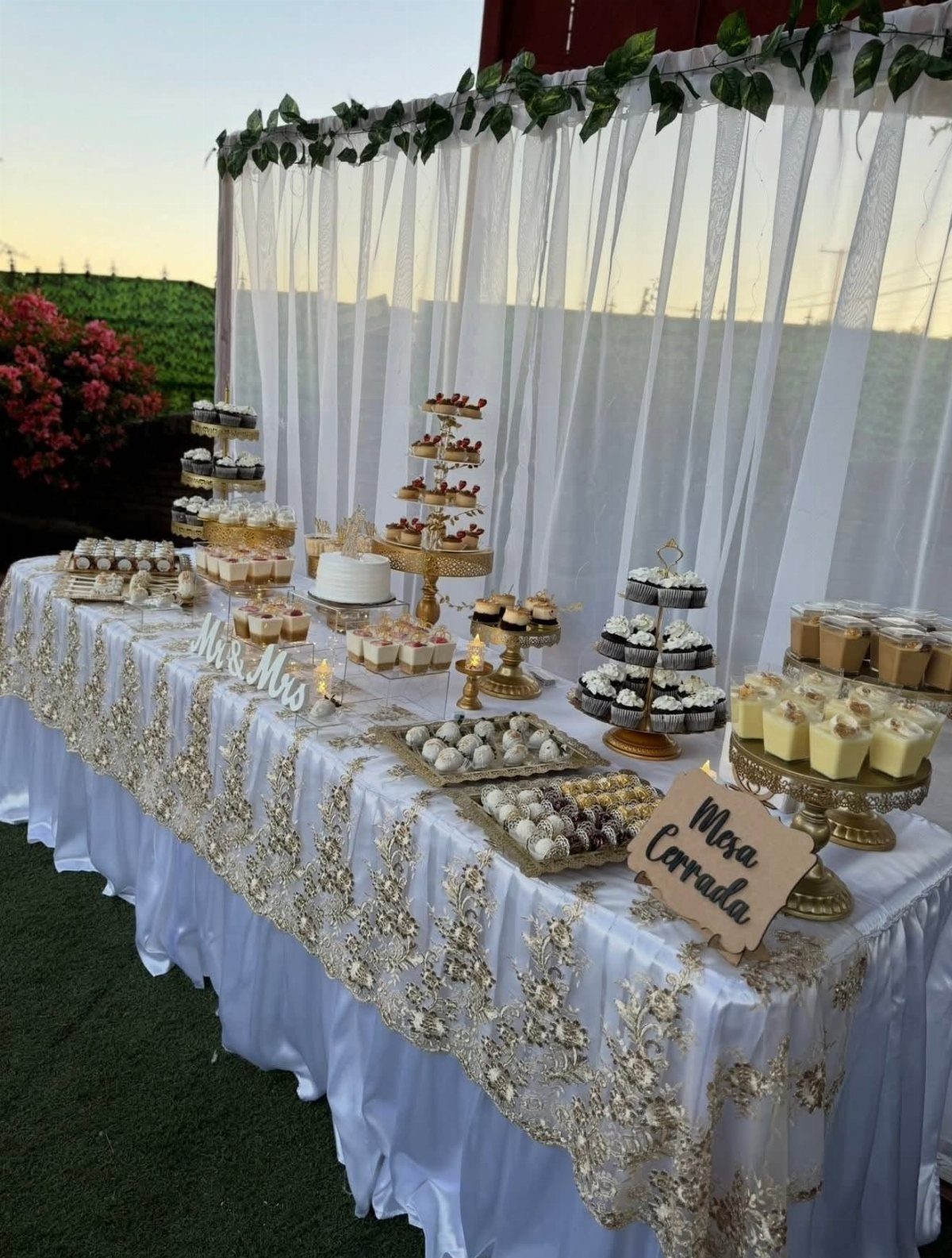 Gold and White Table Decor: 20 Ideas for Parties and Events 14 Dessert table with white and gold cake, cupcakes, and sweets on gold stands.